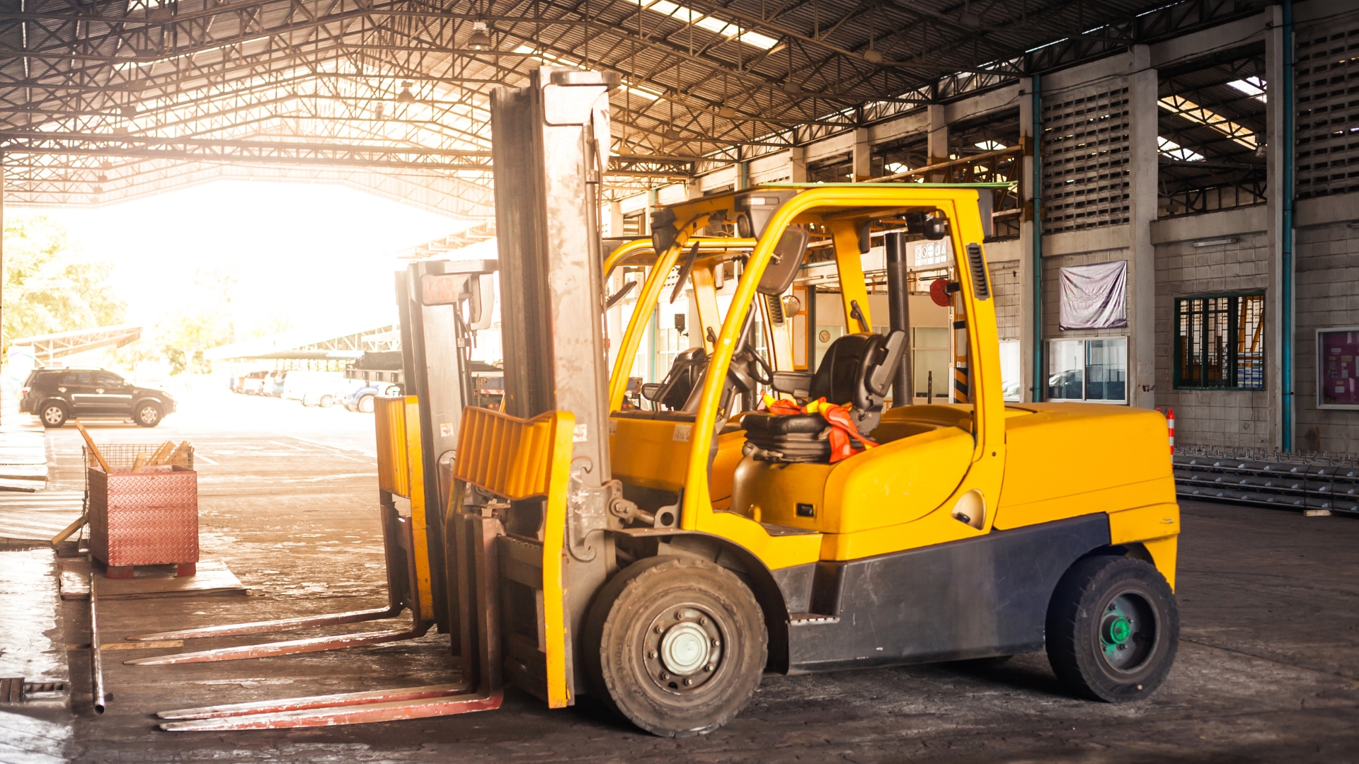 A yellow forklift parked inside of a warehouse