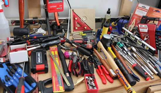 A workbench full of tools, hand equipment, and shop gear — the kind of items Patriot Liquidating purchases directly from individuals and small businesses